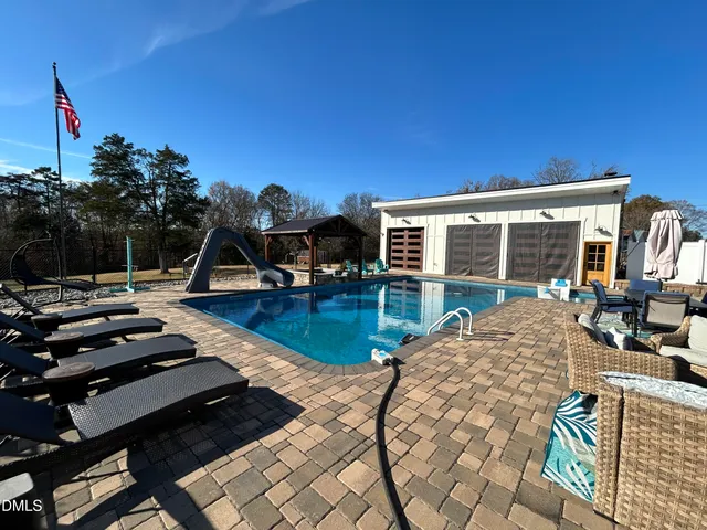 a view of a house with backyard porch and sitting area