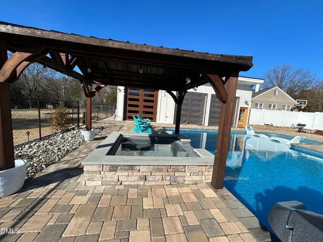 a view of a patio with dining table and chairs with a barbeque grill and couches