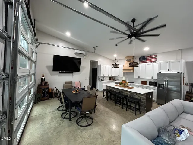 a view of a livingroom with furniture and a flat screen tv