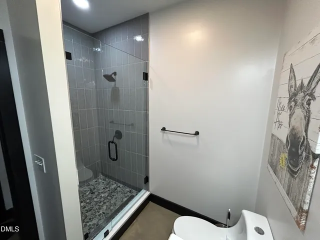 a bedroom with a bed and a ceiling fan