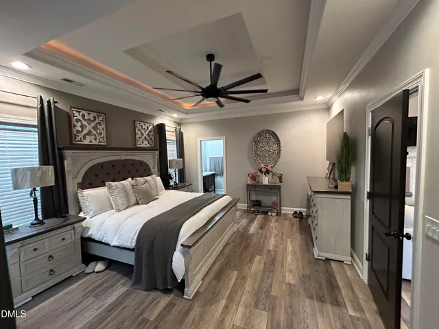 a bedroom with a bed and a chandelier
