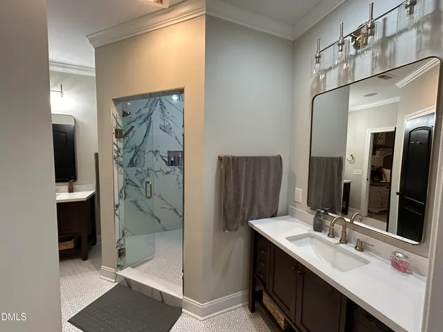 a bathroom with a double vanity sink mirror and shower