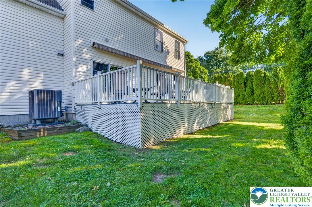 1702 Red Bud Road Quakertown, PA 18951 - Photo 67 of 68 An inviting deck offers generous outdoor living space, perfectly complemented by a green lawn and mature landscaping.