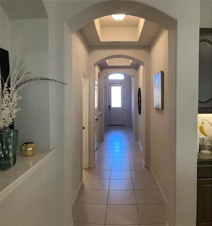 a hallway with sliding door and wooden floor