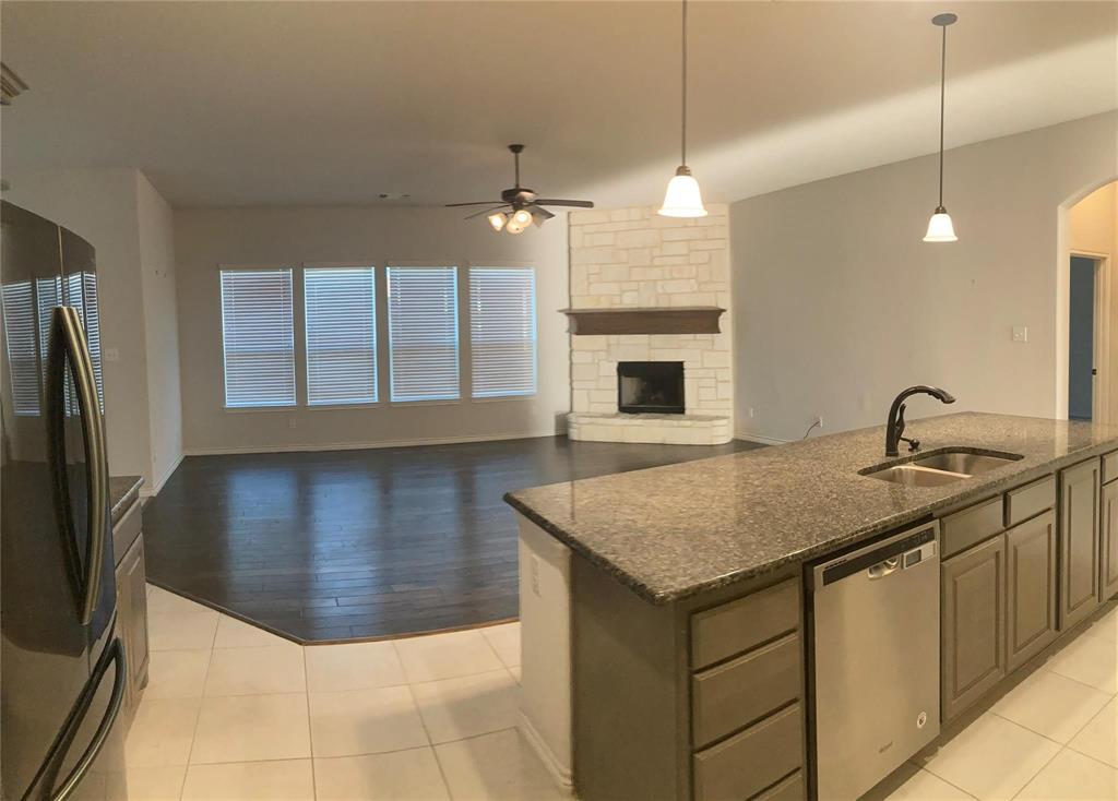 1566 Country Crest Drive Waxahachie, TX 75165 - Photo 4 of 12 a kitchen with a sink refrigerator and microwave