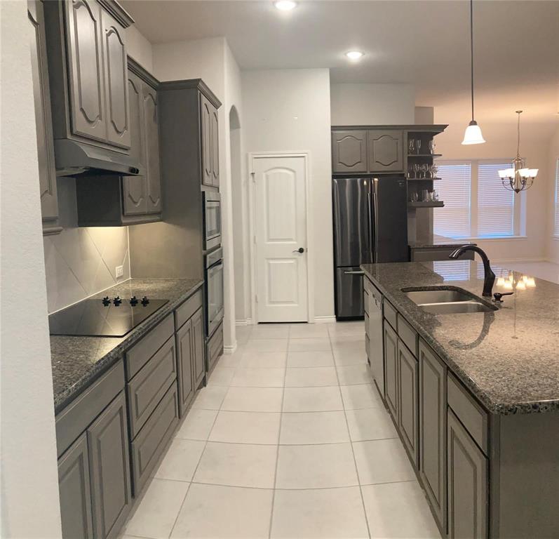 1566 Country Crest Drive Waxahachie, TX 75165 - Photo 9 of 12 a kitchen with granite countertop a sink stove and refrigerator