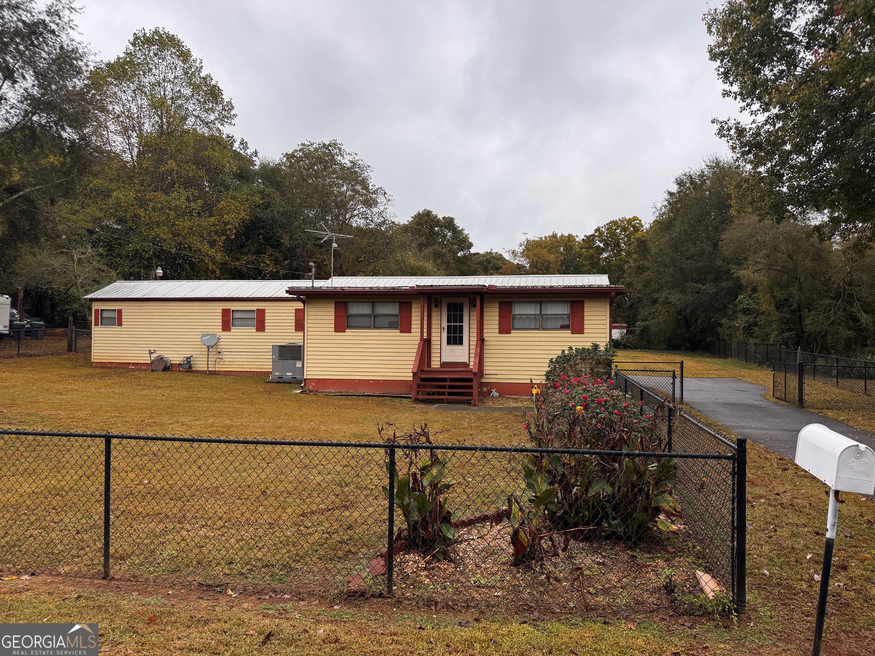 a view of house with backyard and sitting area