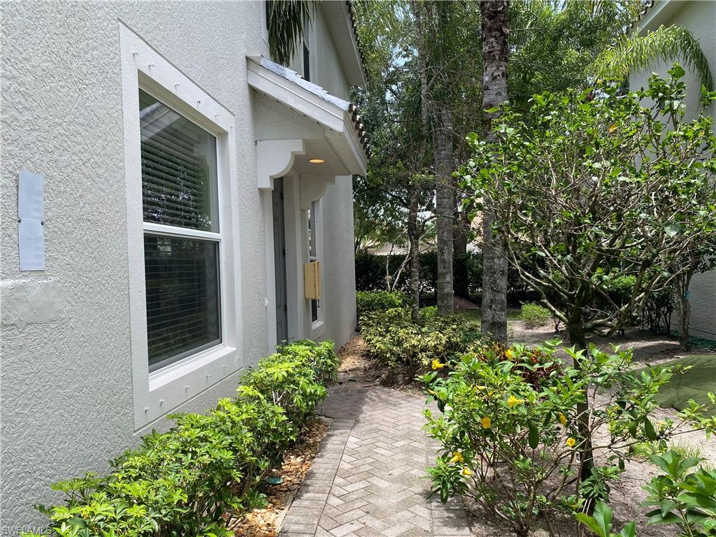16162 Ravina Way, Unit 65 Naples, FL 34110 - Photo 3 of 12 a view of a pathway besides a house