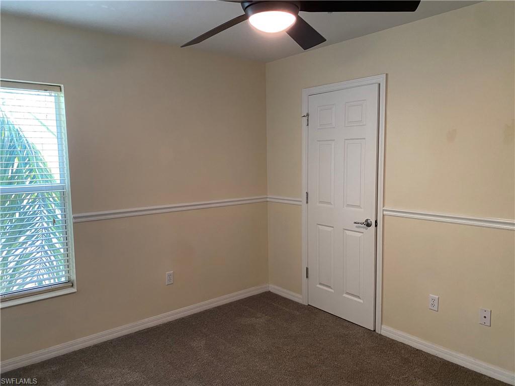 16162 Ravina Way, Unit 65 Naples, FL 34110 - Photo 9 of 12 an empty room with windows and closet