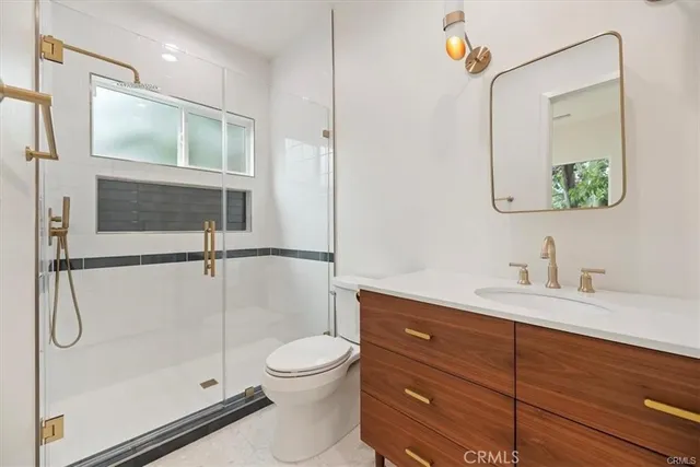 a bathroom with a shower sink vanity and mirror
