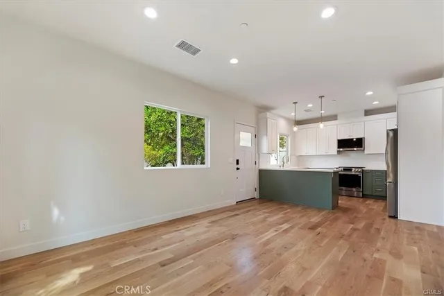 a kitchen with a refrigerator and a sink