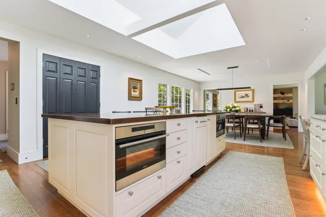 a large kitchen with cabinets a sink and a stove