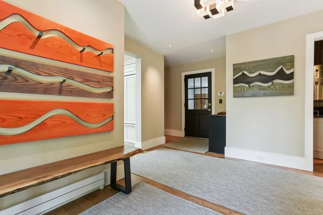a kitchen with white cabinets and sink