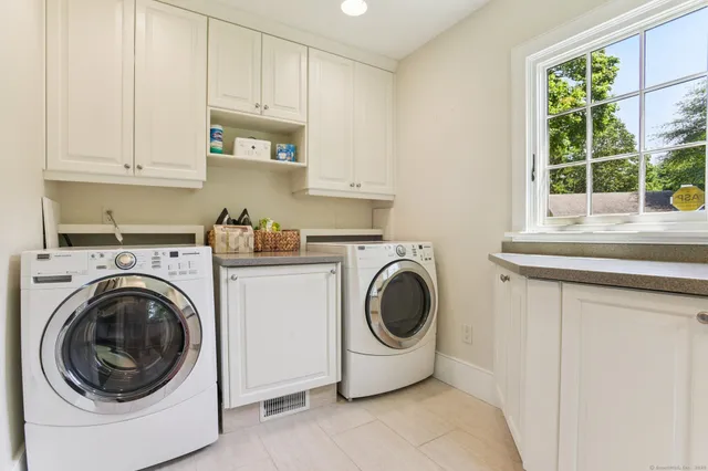 a view of hallway with a large window and wooden floor