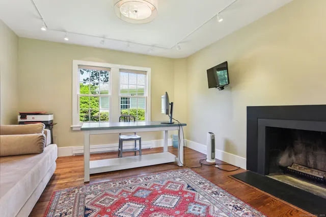 a bathroom with a toilet sink and mirror on the wall