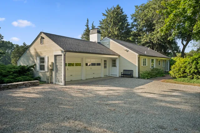 a kitchen with stainless steel appliances granite countertop a stove a refrigerator a microwave oven with a dining table and chairs