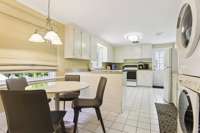 a view of a house with a yard and sitting area