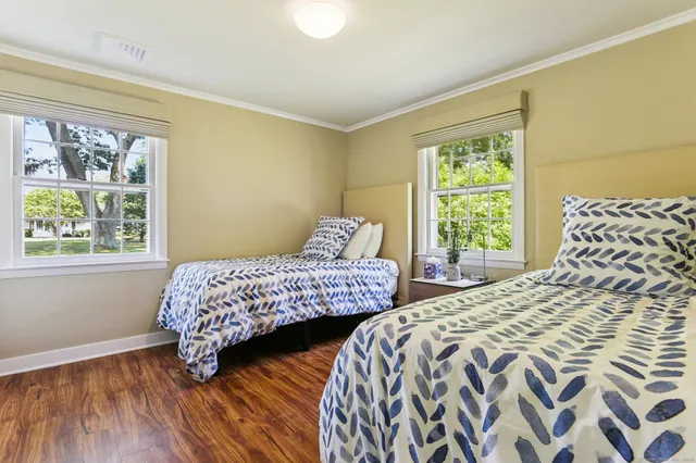 a living room with furniture and floor to ceiling windows
