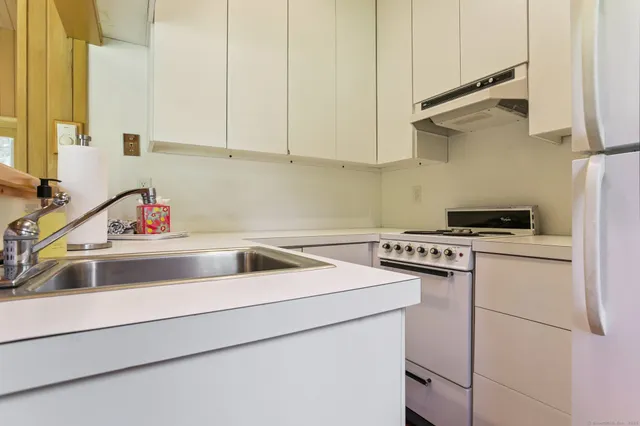 a view of a swimming pool with a yard and plants