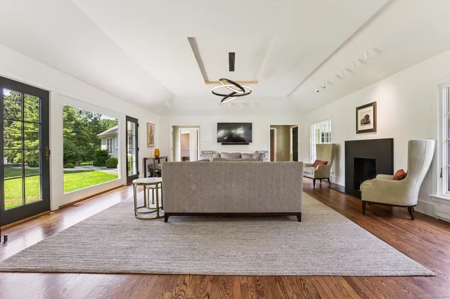 a living room with furniture fireplace and a large window