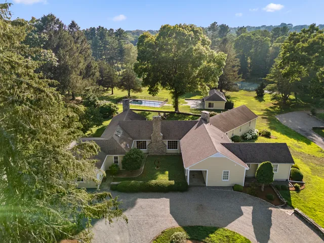 an aerial view of a house with a yard