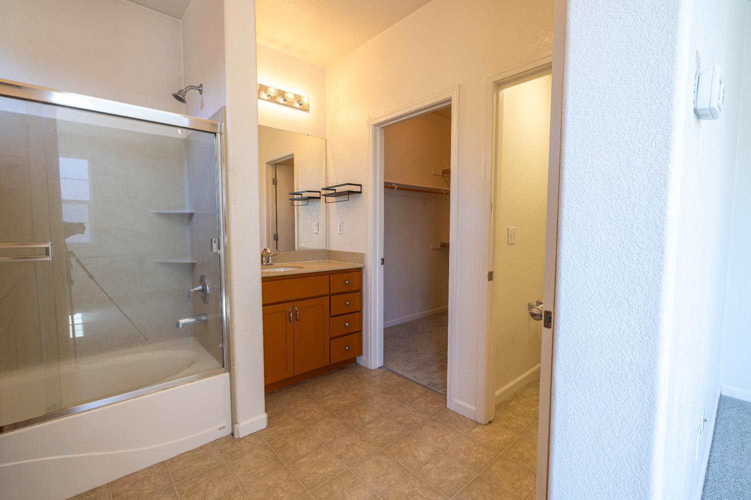 3122 Lea Sterling Way Rancho Cordova, CA 95670 - Photo 16 of 31 a bathroom with a tub and shower