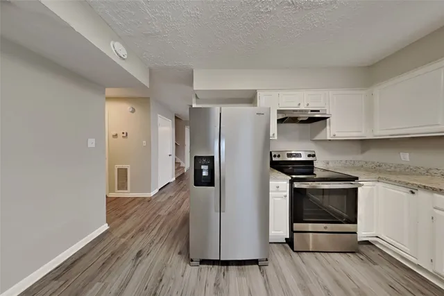a kitchen with stainless steel appliances a refrigerator stove and sink