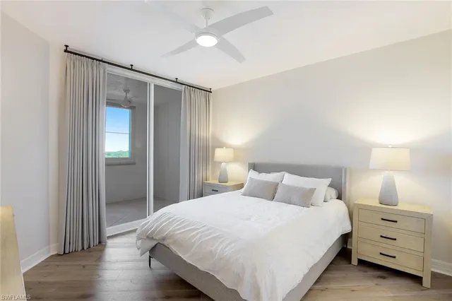 a bedroom with a bed and a night stand