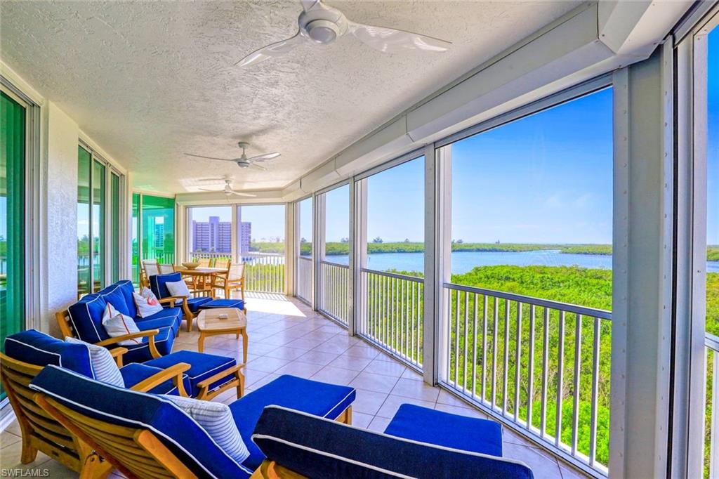 295 Grande Way, Unit 404 Naples, FL 34110 - Photo 18 of 27 a living room with furniture and a floor to ceiling window