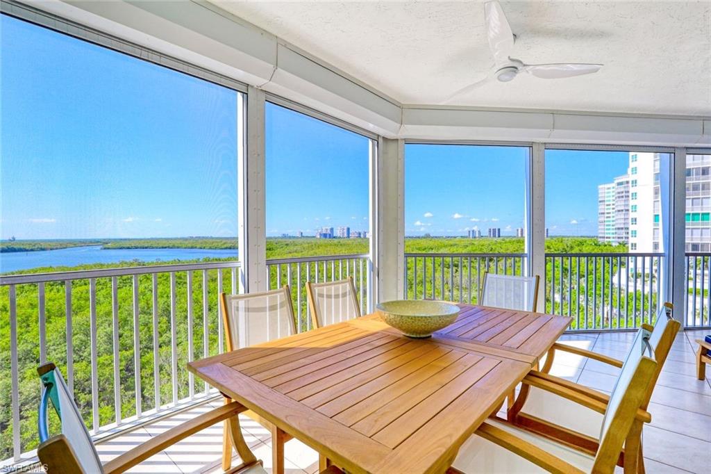 295 Grande Way, Unit 404 Naples, FL 34110 - Photo 20 of 27 a view of a patio with wooden floor and outdoor space