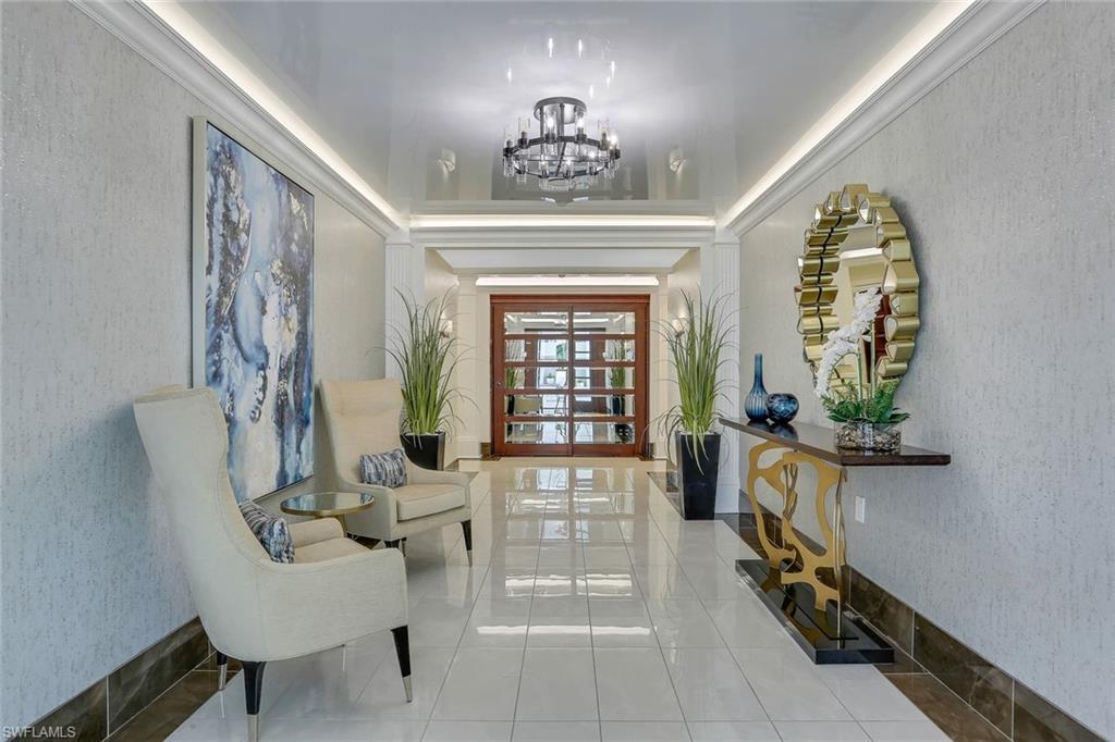 295 Grande Way, Unit 404 Naples, FL 34110 - Photo 21 of 27 workspace with fireplace and furniture