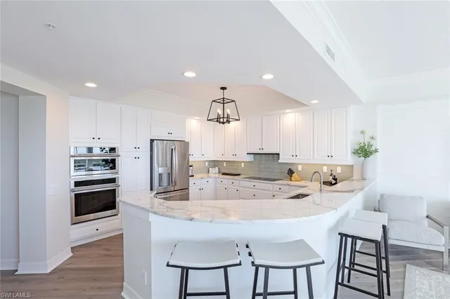 a kitchen with kitchen island appliances and cabinets