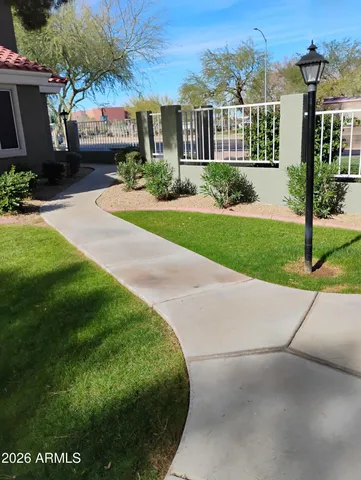 a front view of a house with a yard and potted plants