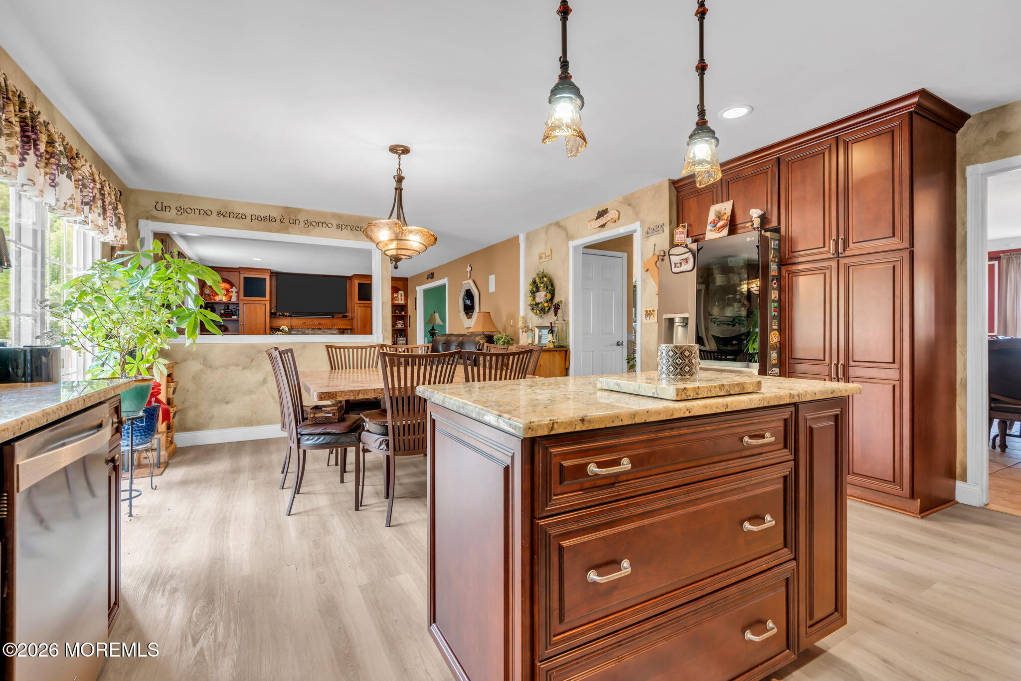 21 Ryan Road Marlboro, NJ 07746 - Photo 12 of 56 a kitchen with a stove a refrigerator and a dining table with wooden floor