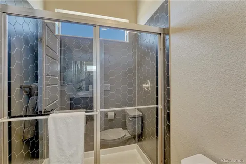 a bathroom with a shower and toilet