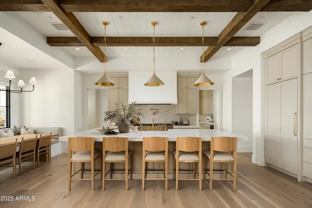 a kitchen with white cabinets and appliances