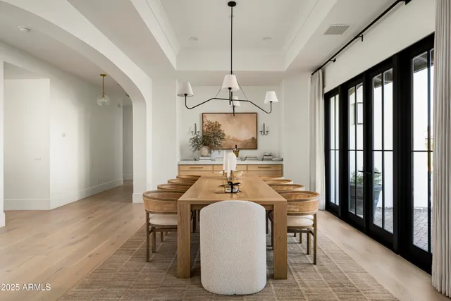 a spacious bedroom with a large bed and a flat screen tv