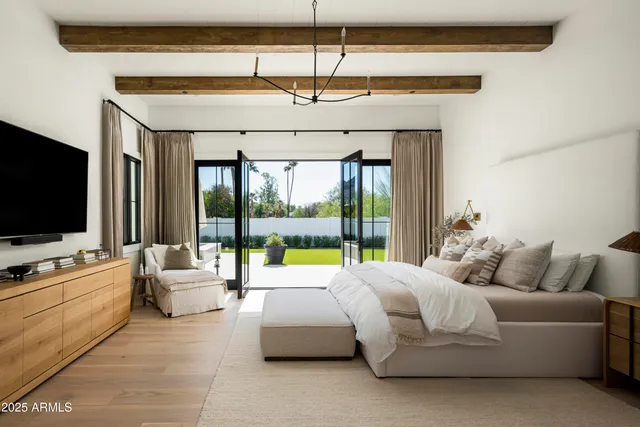 a bedroom with a bed and a large window