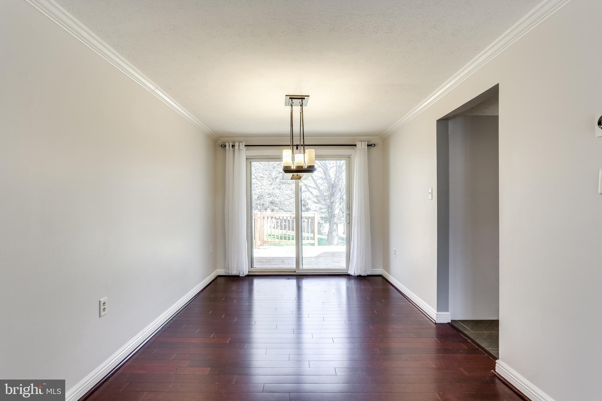 7843 Metacomet Road Hanover, MD 21076 - Photo 6 of 33 Large dining room leading to deck.