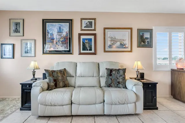 a living room with furniture and a lamp
