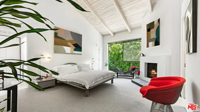 a living room with furniture fireplace and window