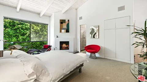 a bed room with a bed and a fireplace