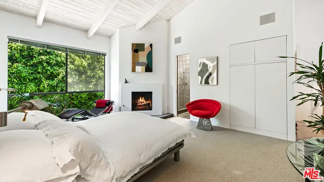 a bed room with a bed and a fireplace