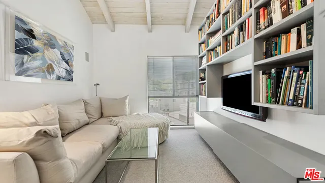 a living room with furniture water view and a flat screen tv