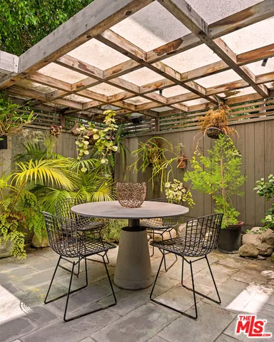 a patio with a table and chairs