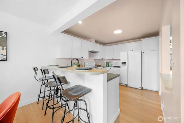 a kitchen with a table chairs and a refrigerator