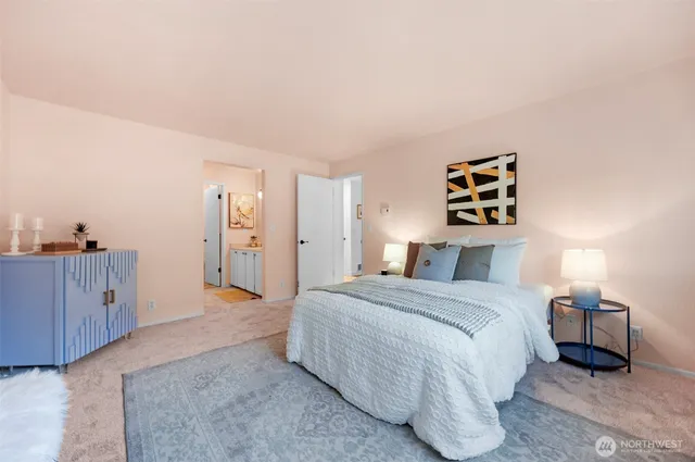 a spacious bedroom with a bed and a dresser