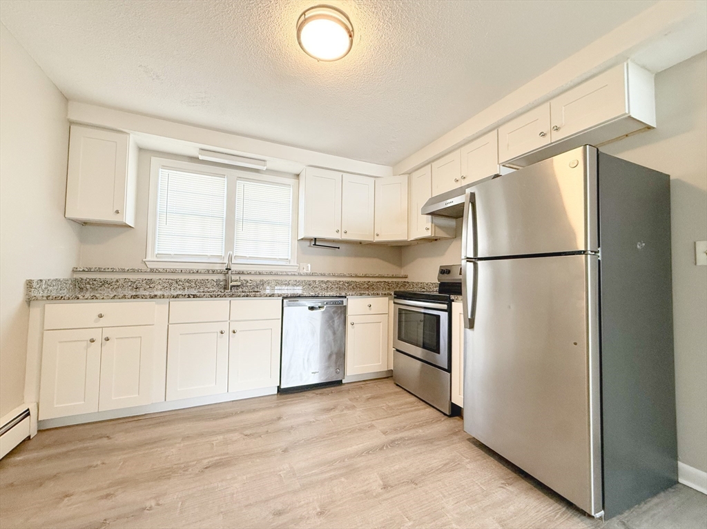5 Meisner Circle, Unit 25 Salem, NH 03079 - Photo 2 of 6 a kitchen with granite countertop stainless steel appliances a refrigerator a sink and cabinets
