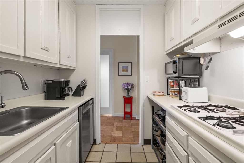 85 East India Row, Unit 36G Boston, MA 02110 - Photo 16 of 29 a kitchen with stainless steel appliances granite countertop a sink stove and refrigerator