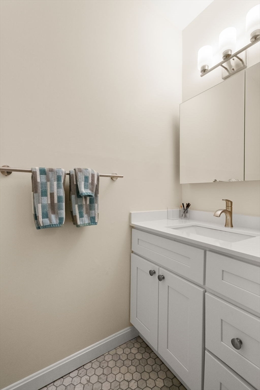 85 East India Row, Unit 36G Boston, MA 02110 - Photo 19 of 29 a bathroom with a sink and a mirror